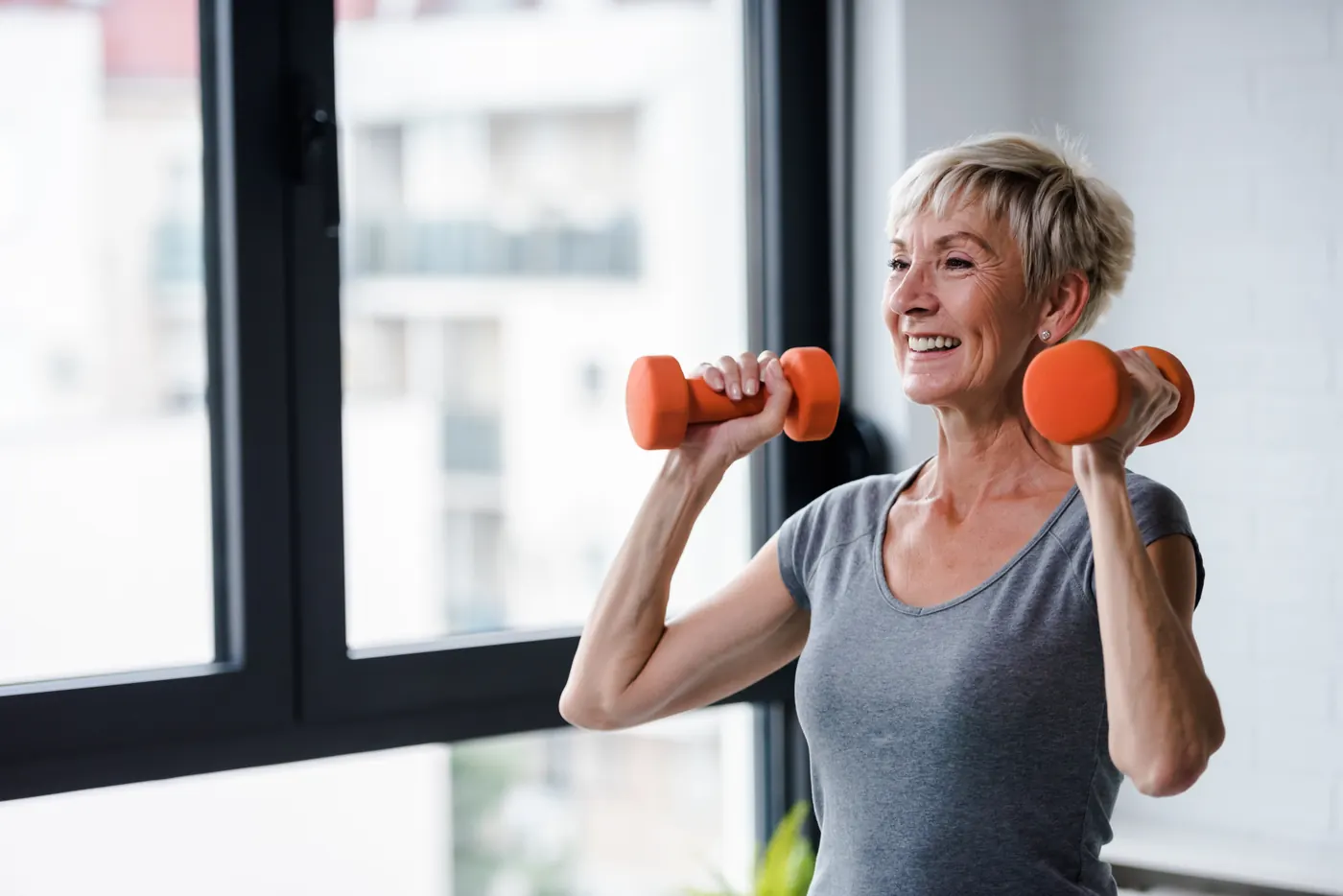 Senior woman lifting dumbbells