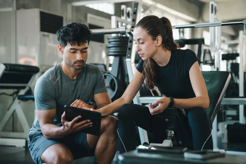 A coach and client reviewing a training plan together